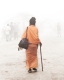 indian sadhu is walking trough the mist in varanasi india